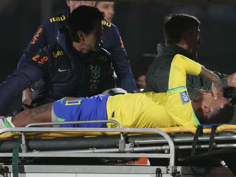 Brazil's Neymar is carried off the pitch on a stretcher.