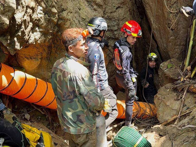 Rescuers race to reach seven trapped in a Laos cave