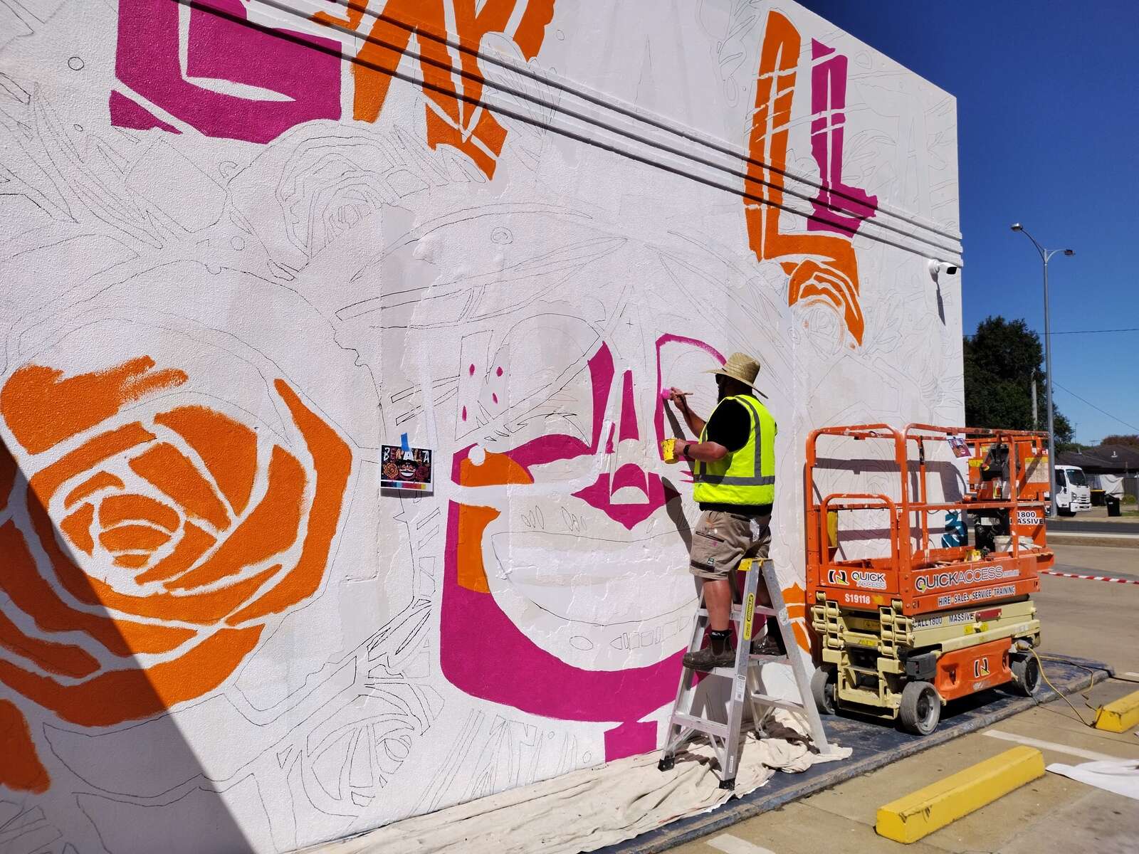 Travis Price enjoying painting iconic Benalla Street Art Festival wall