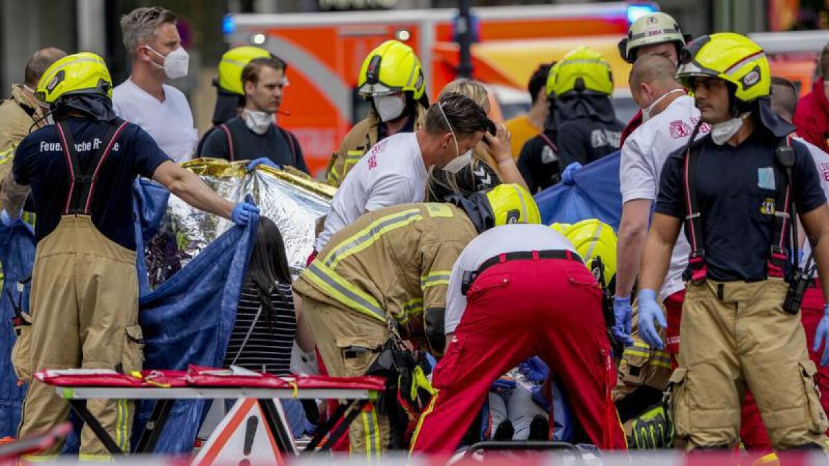 Rescuers help the injured after a car crashed into a crowd in Berlin.