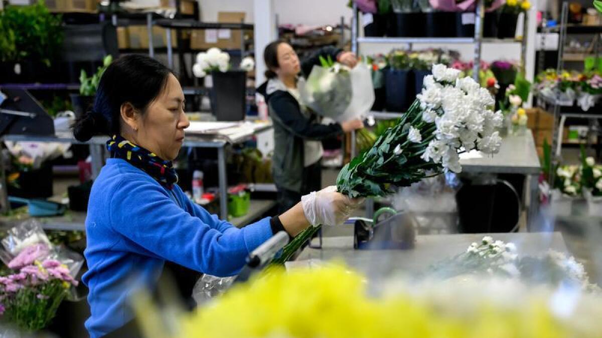 Florists prepare bouquets in a Sydney warehouse.