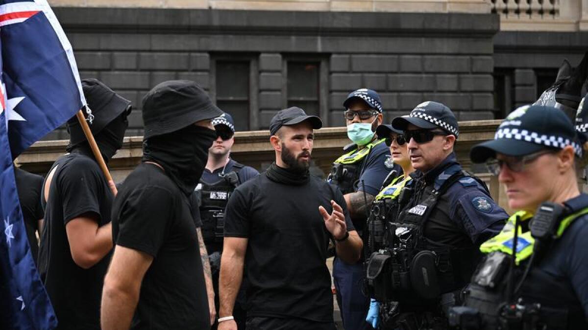 Neo-Nazis face off with police at a demonstration in Melbourne