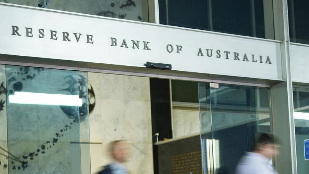 People walk out of the Reserve Bank building in Sydney.