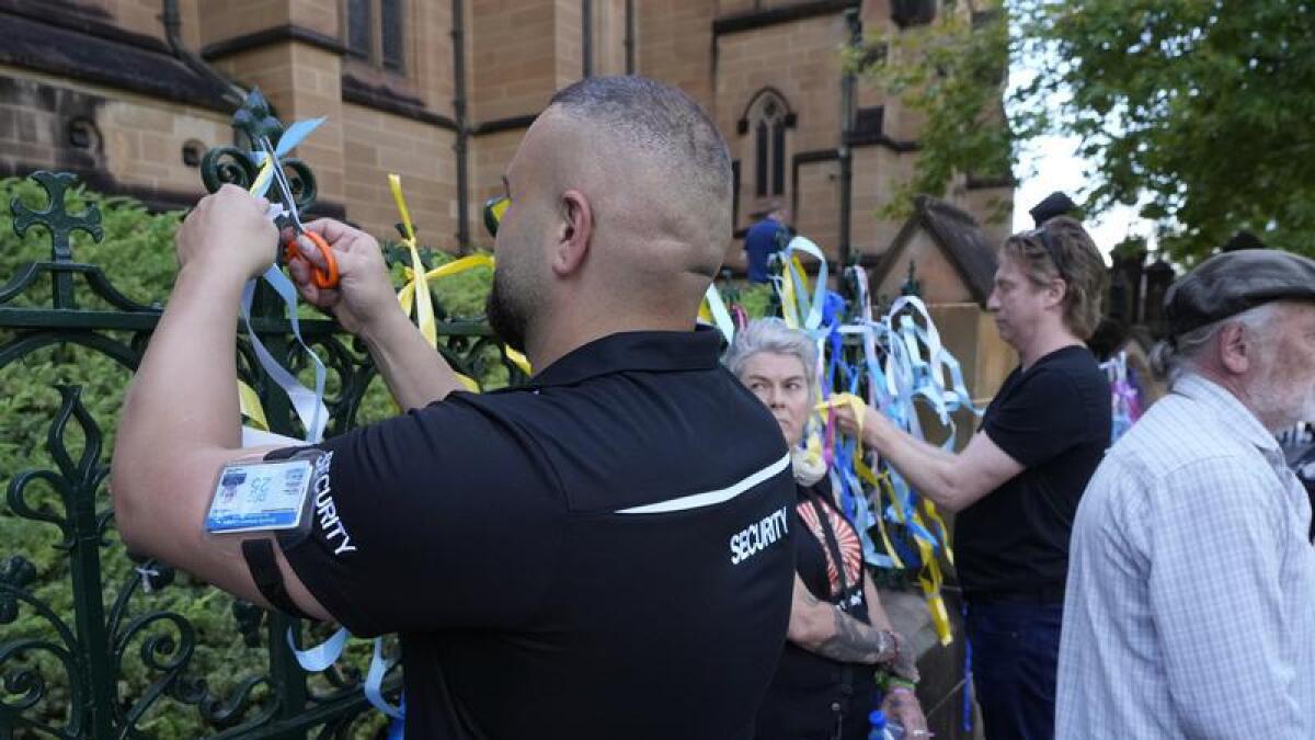 Security guard removes ribbons left by protesters (file image)