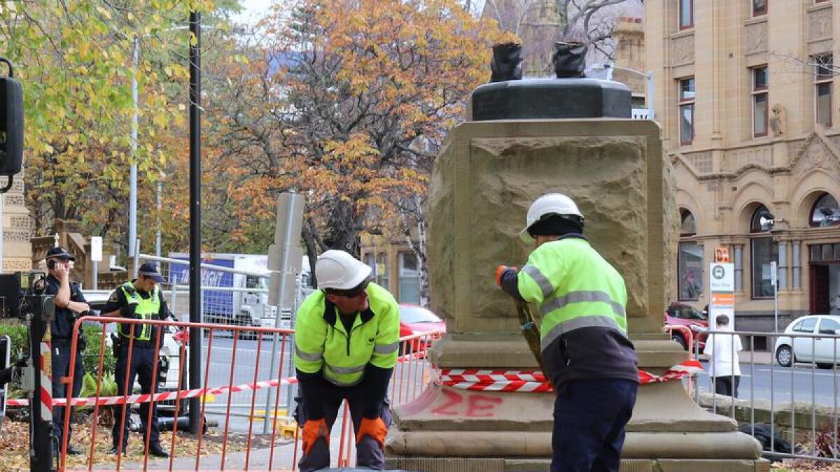 Council workers remove the statue on Wednesday.