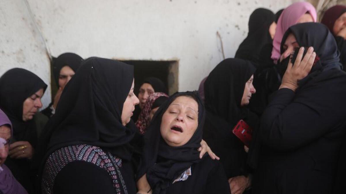Mourners attend the funeral of a Palestinian in the village of Azzoun