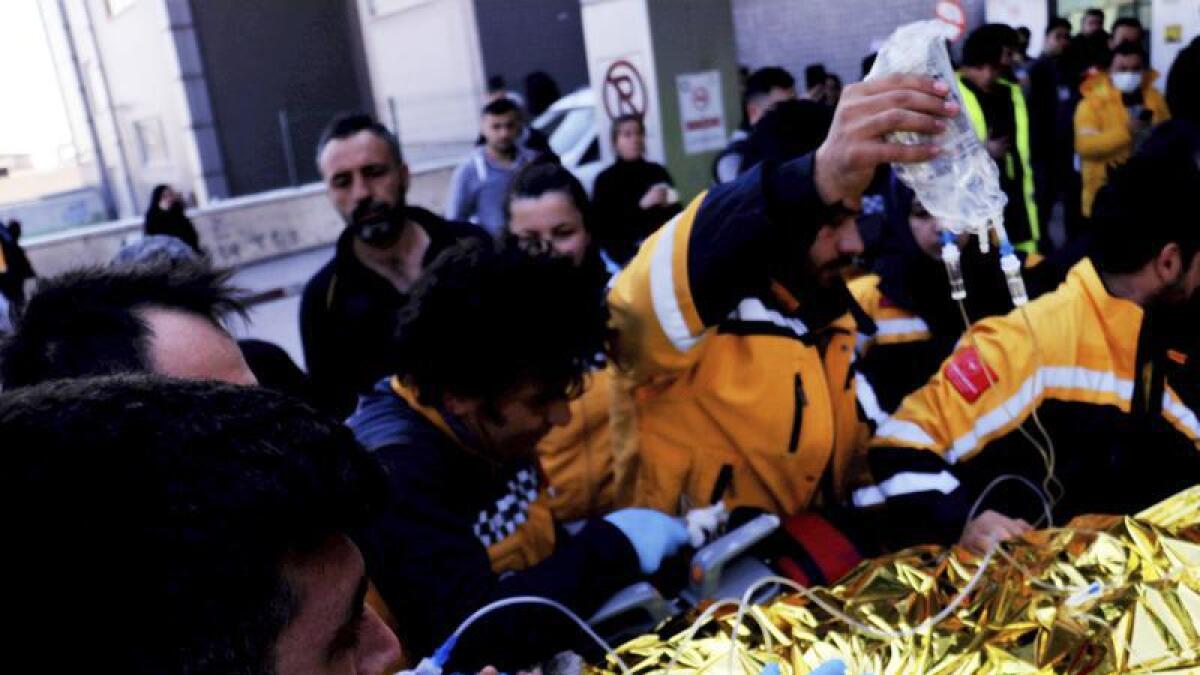 A survivor is pulled from rubble in Antakya, Turkey