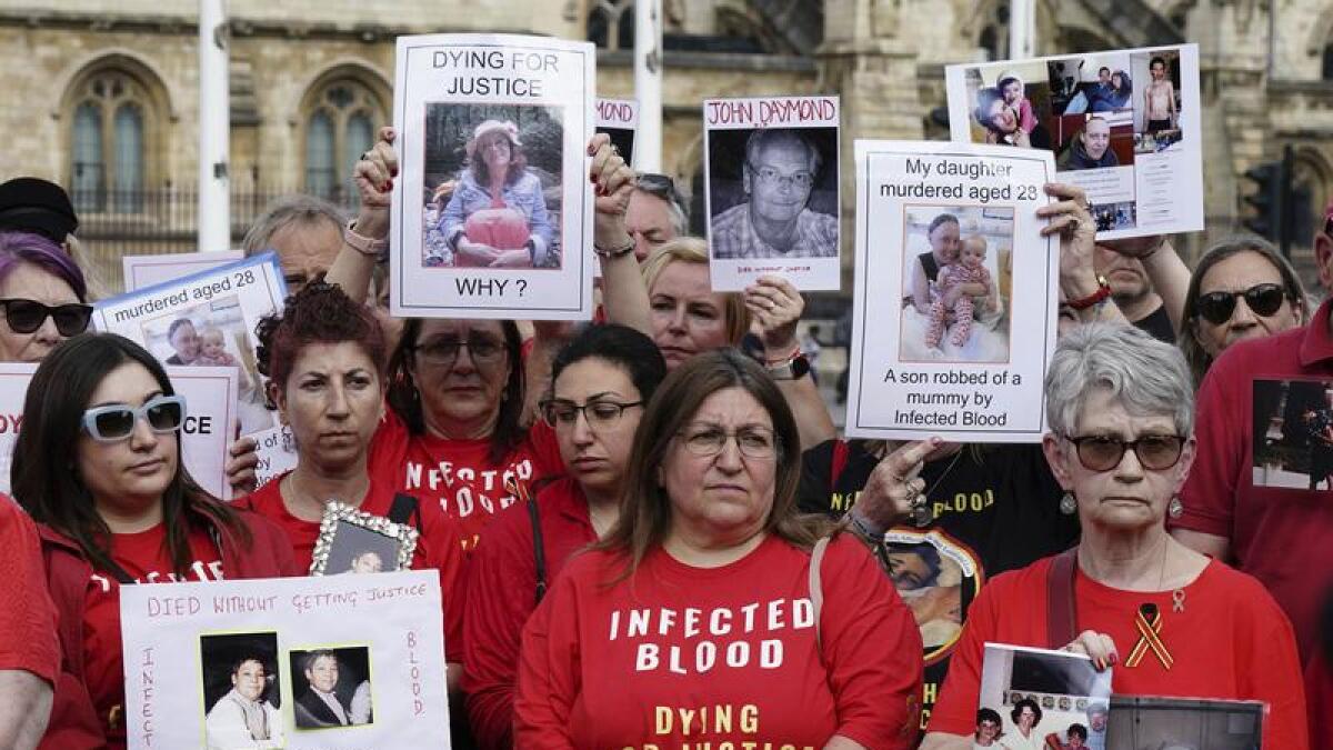Infected blood campaigners gather in Parliament Square in London