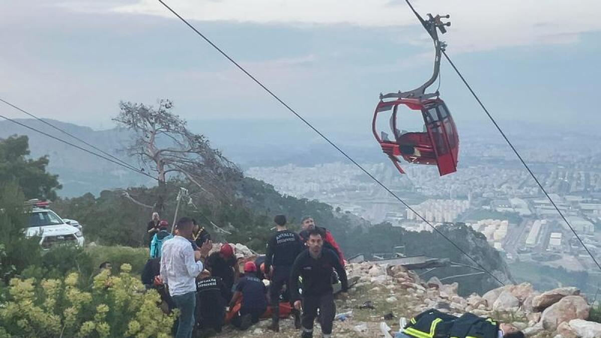 Emergency team members work with passengers after a cable car accident