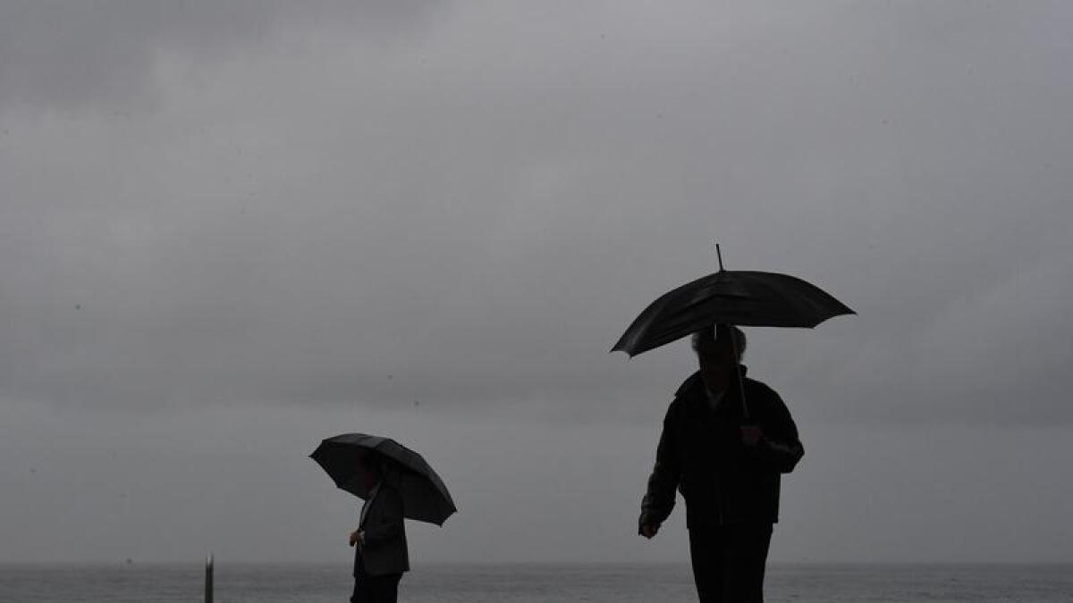 People walk in the rain in Sydney