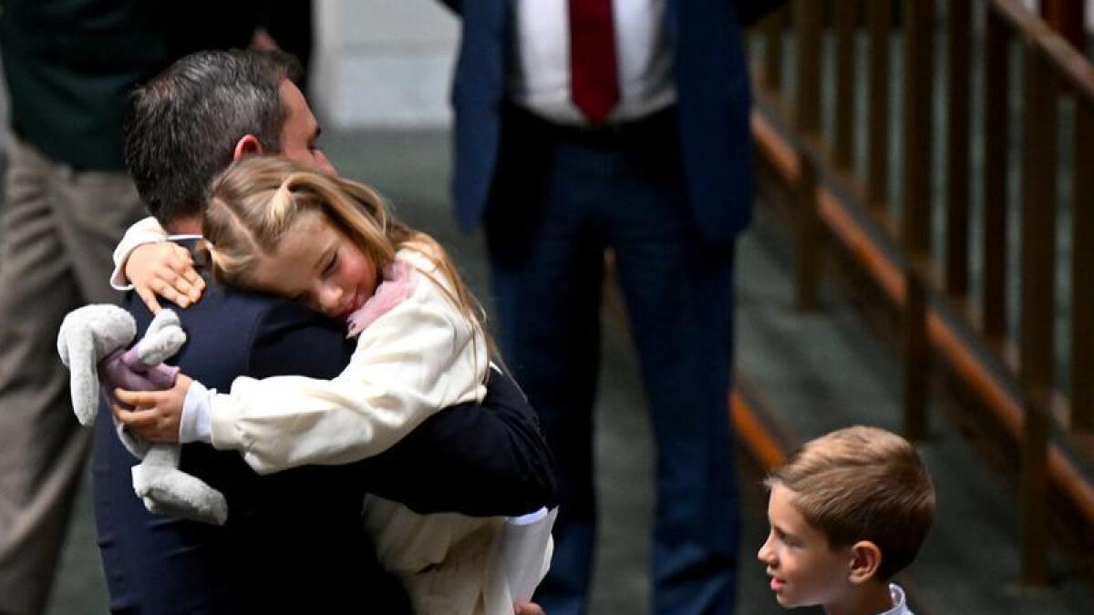 Jim Chalmers hugs his daughter