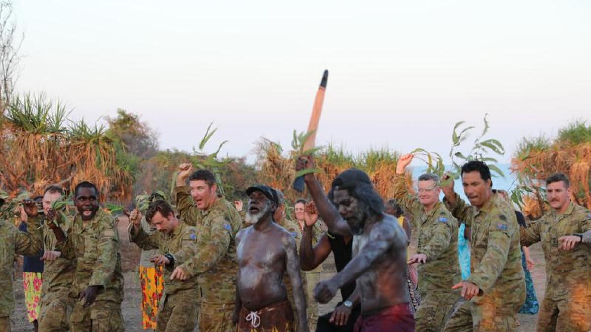 Soldiers and Indigenous leaders dancing at the commemorations.