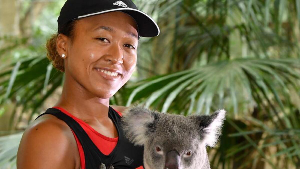 Tennis champion Naomi Osaka with a koala at Lone Pine Koala Sanctuary.