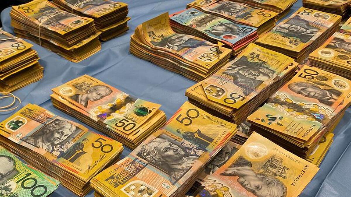 NSW Police have arrested a man after $1m was found in a ute and home.
