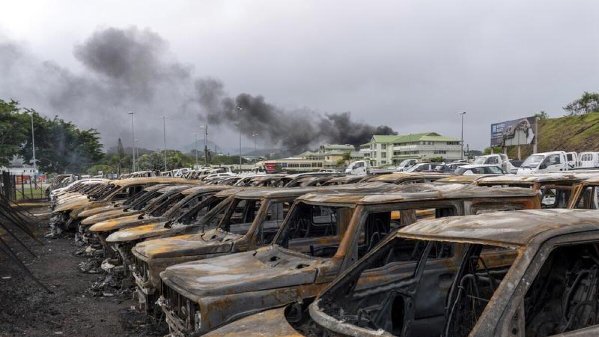 Burnt cars are lined up after unrest in Noumea, New Caledonia