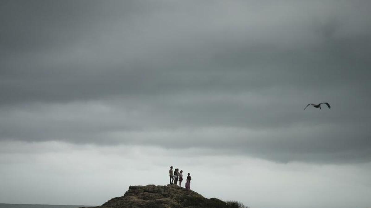 People standing on a rocky outcrop after the hurricane