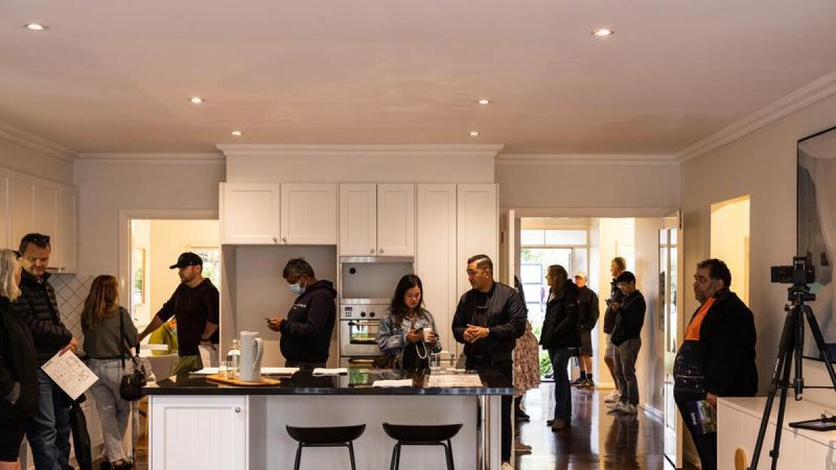 Bidders inside a home during an auction at Glen Iris in Melbourne