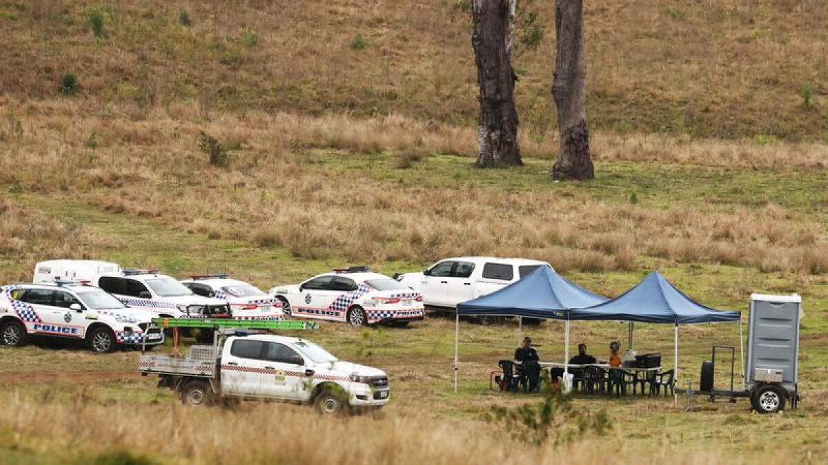 Police near the scene of a light plane crash west of Brisbane