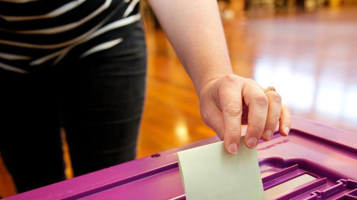 A voter posts their ballot paper.