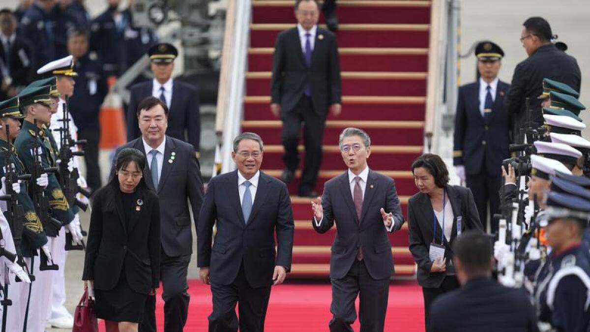 Chinese Premier Li Qiang is welcomed by South Korea's Kim Hong-kyun