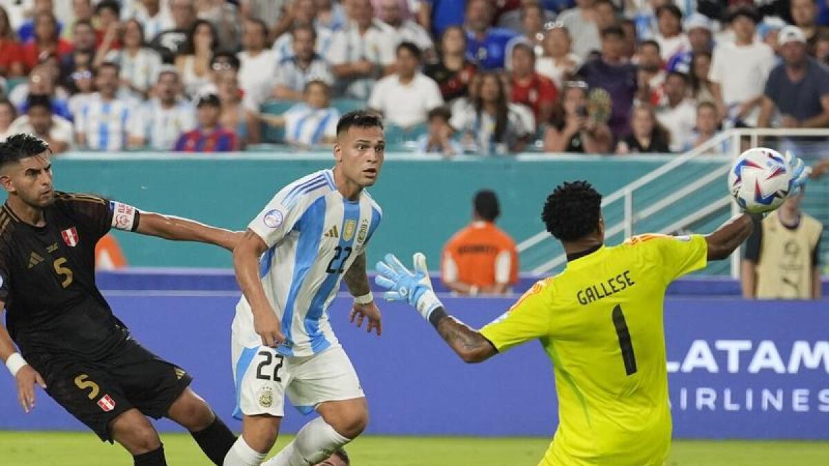 Lautaro Martinez (22) chips Pedro Gallese to put Argentina 2-0 up.