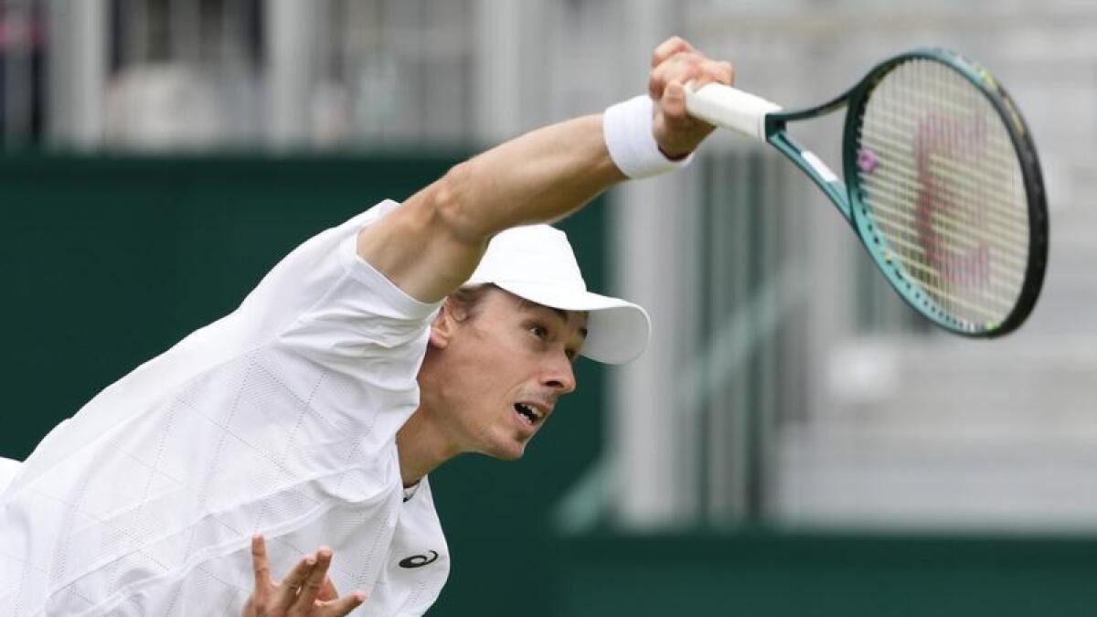 Alex de Minaur serves at Wimbledon.