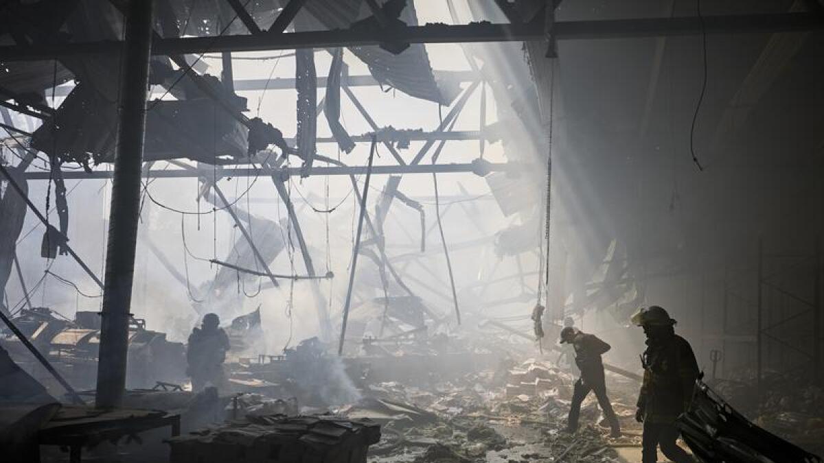 Rescuers work at the site of a shelling on a printing house in Kharkiv