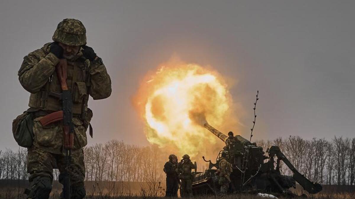 Ukrainian soldiers fire artillery at Russian positions
