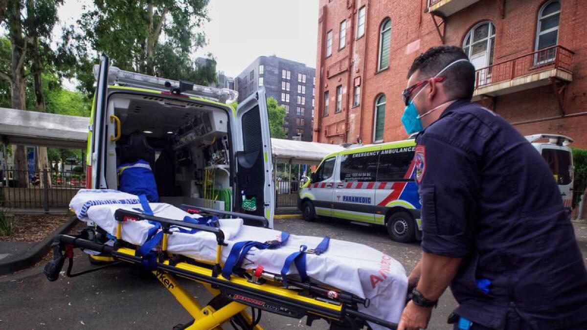 A paramedic moves equipment outside St. Vincent's Hospital, Melbourne