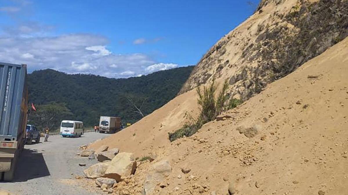 Debris lies strewn across a highway following a landslide