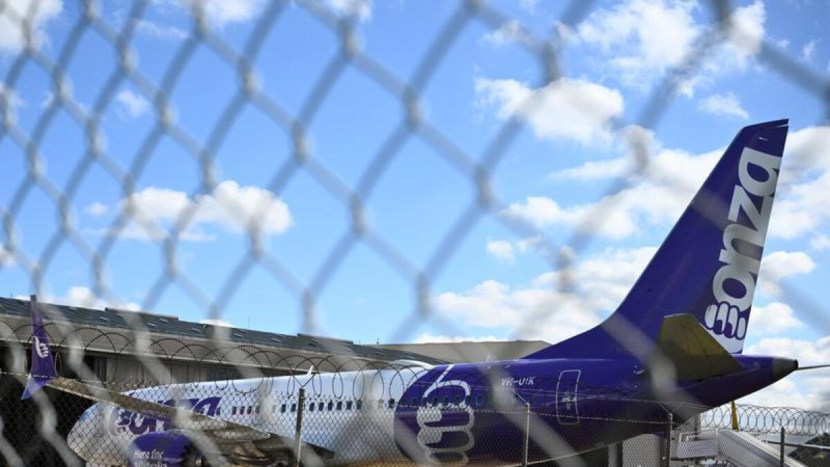 Bonza 737 MAX aircraft behind a fence