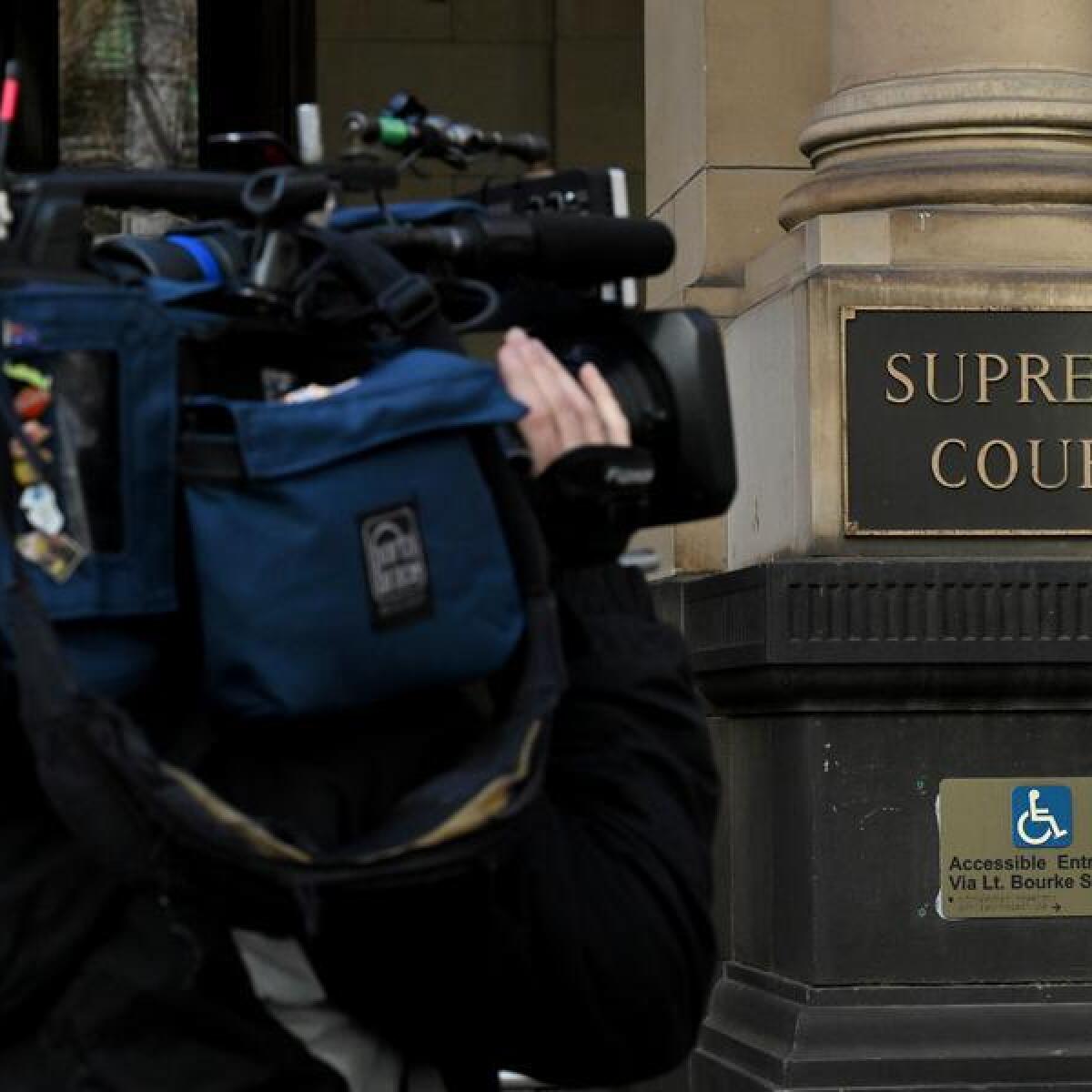 A tv cameraman next to signage of the Supreme Court (file image)