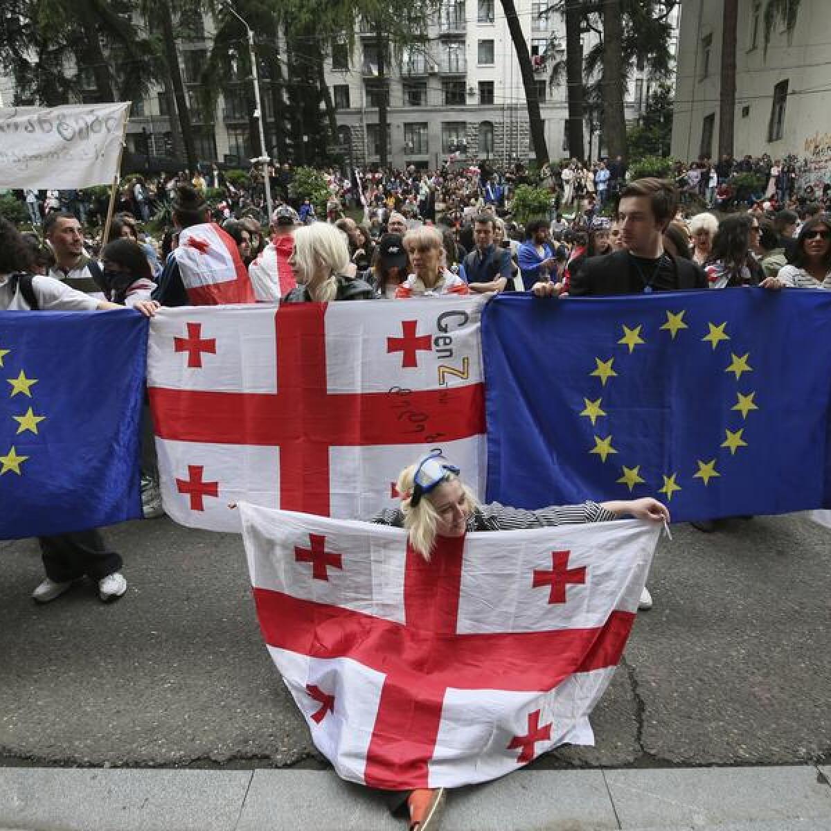 Demonstrators with Georgian national and EU flags