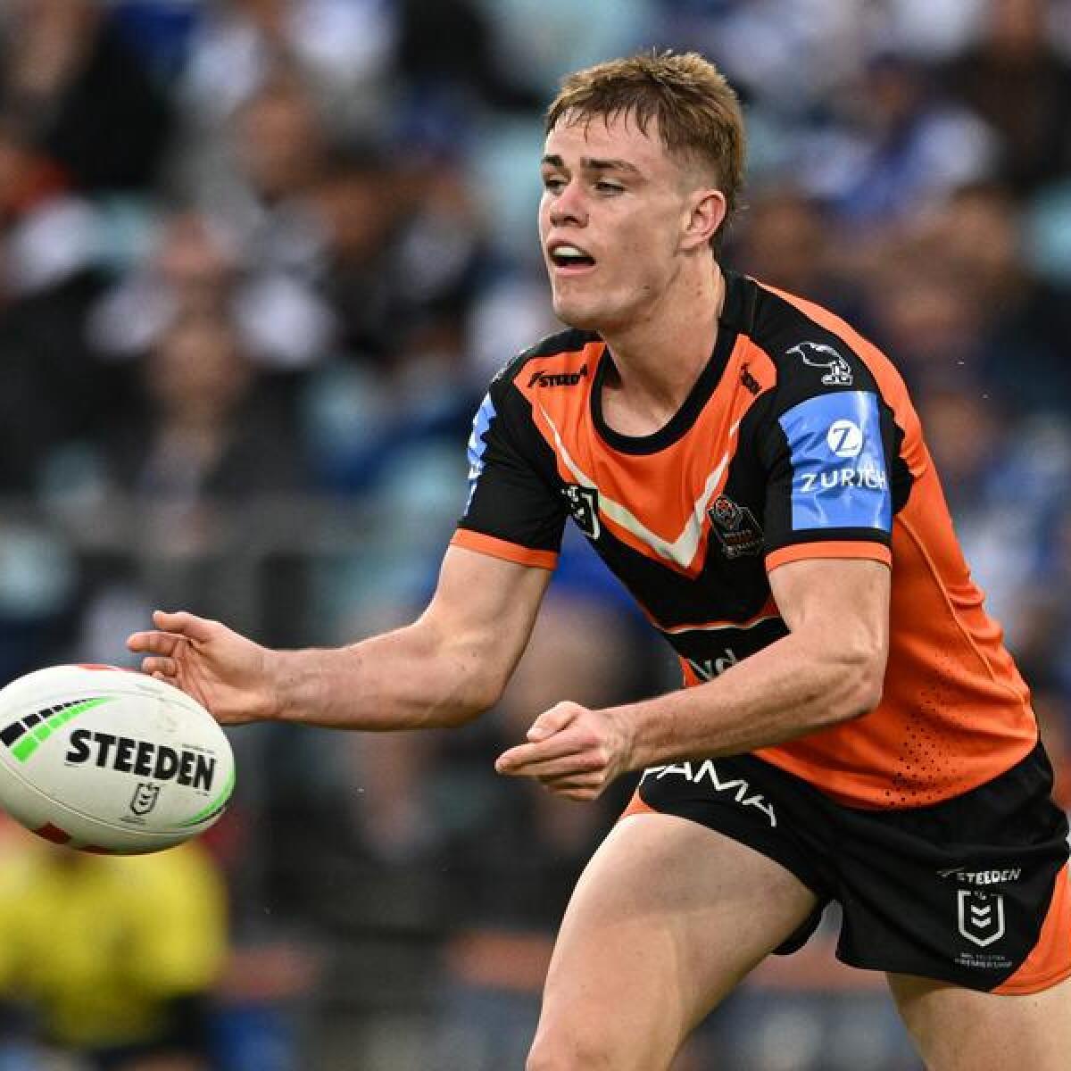Lachlan Galvin passes the ball for Wests Tigers. 