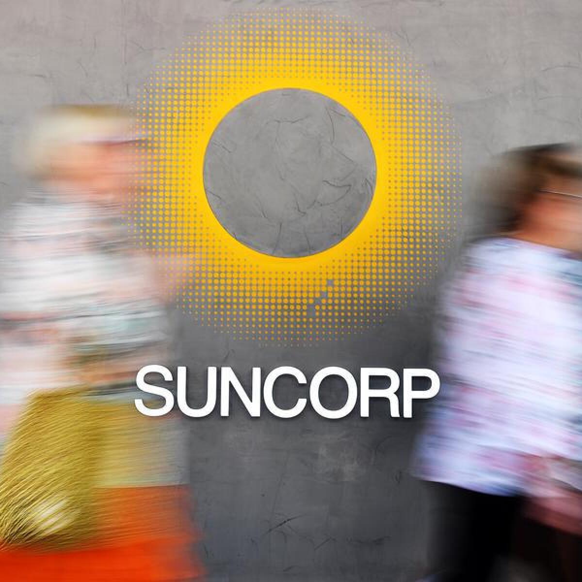 Shoppers walk past a Suncorp bank office (file image)