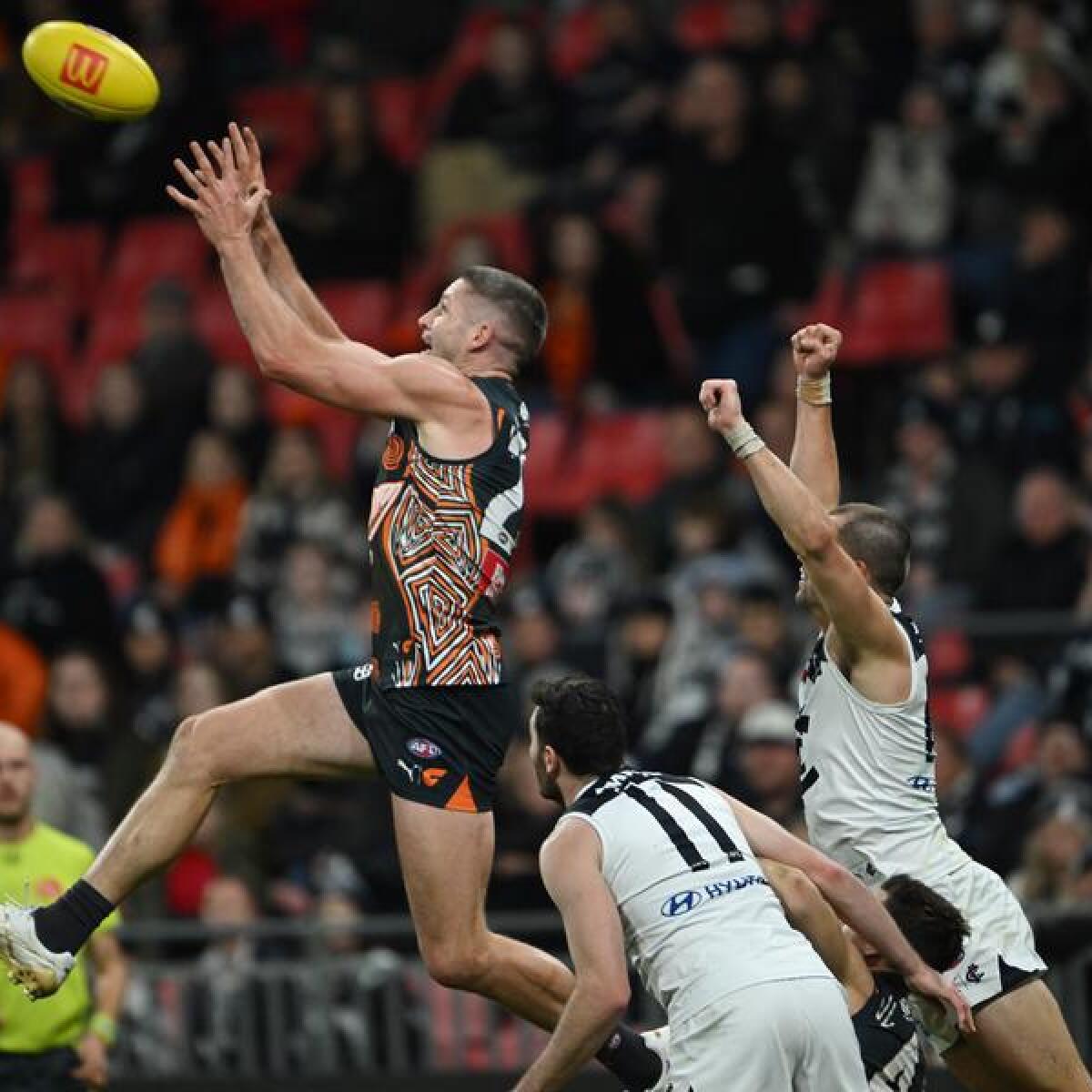 Jesse Hogan leaps high for the Giants.