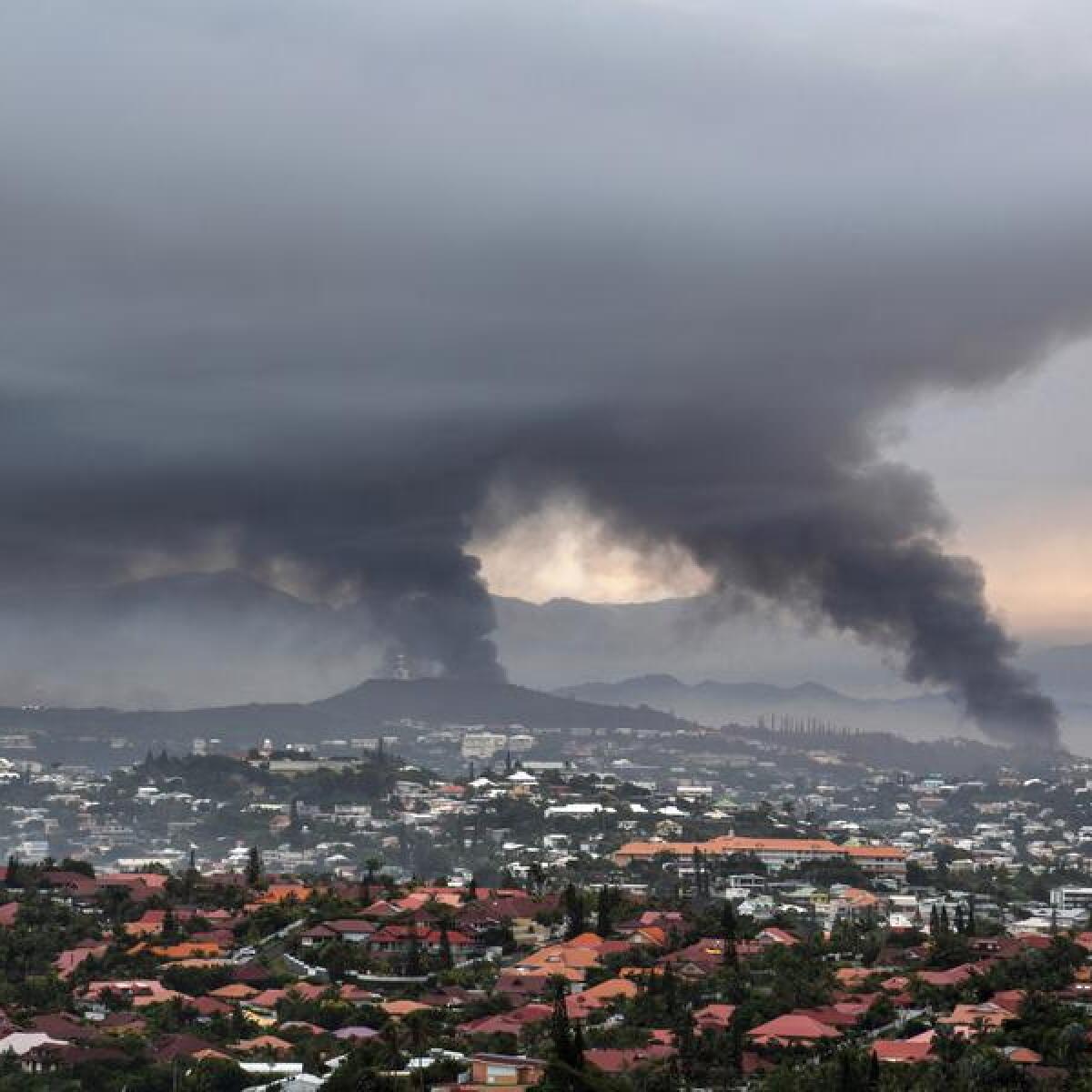 Smoke rises during protests in Noumea