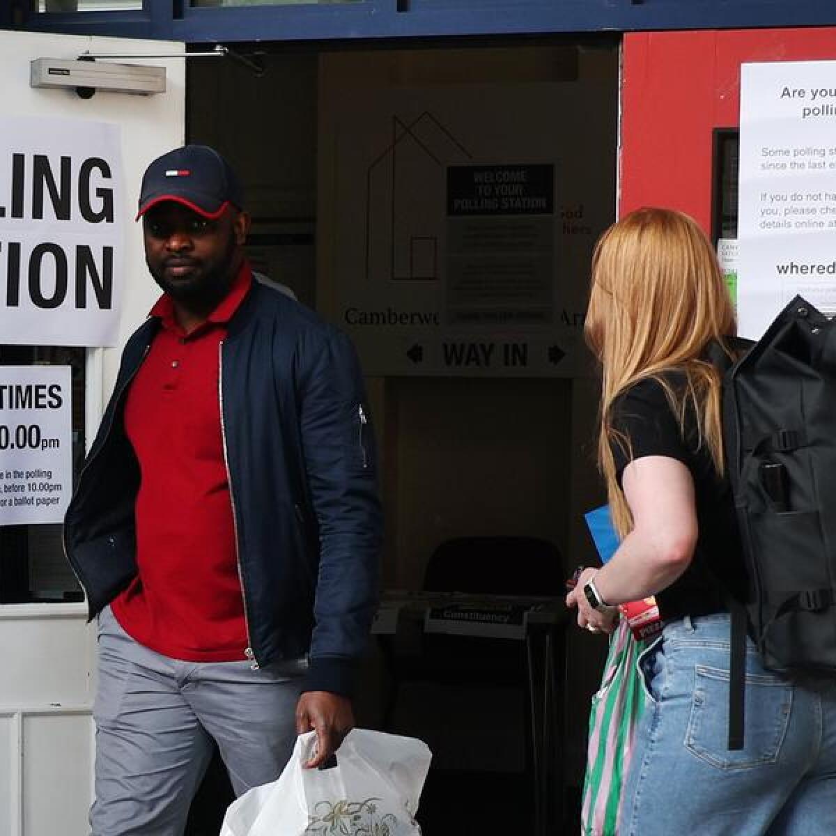 Voters exit a polling station in London