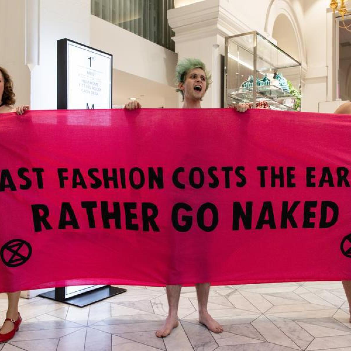Three people protesting fast fashion.