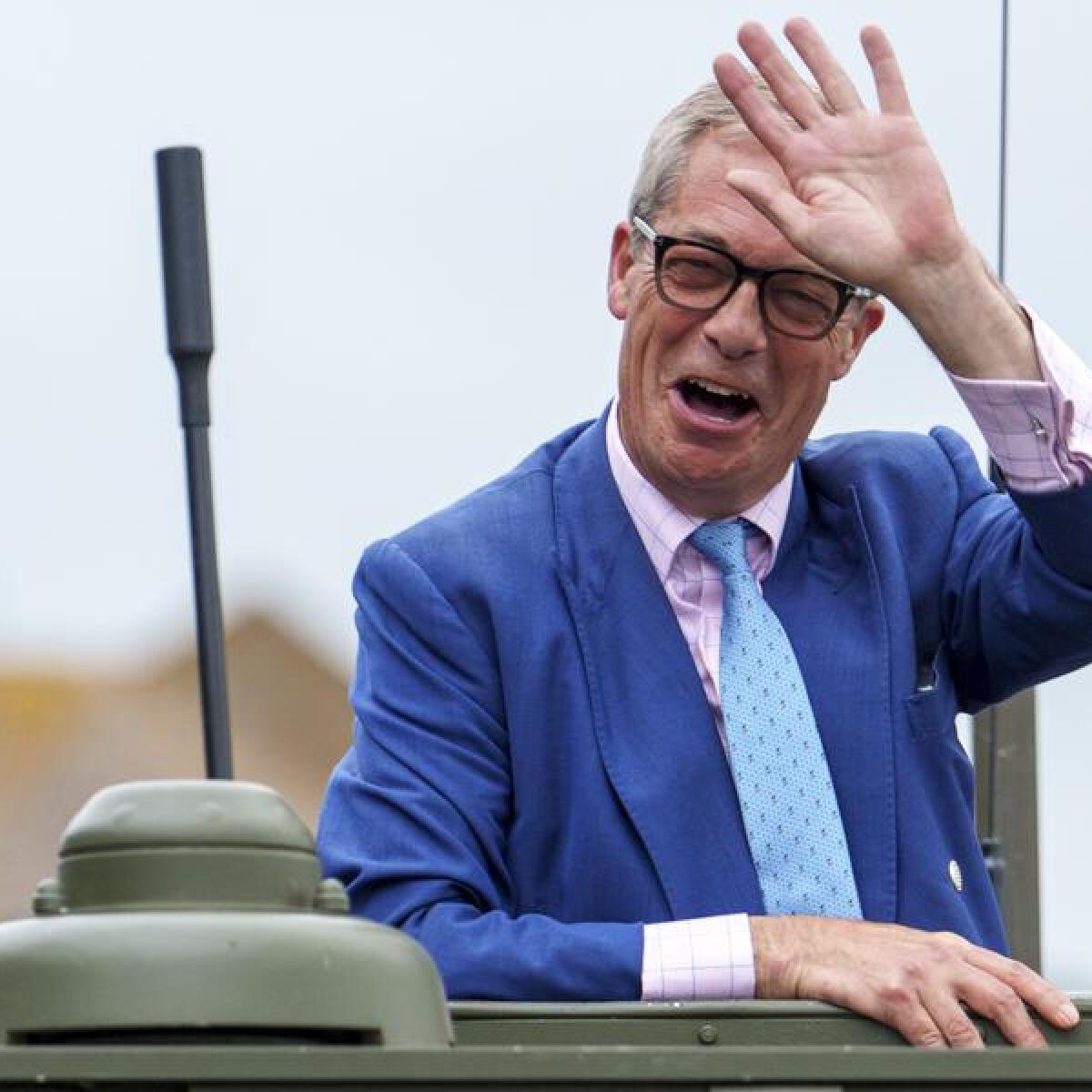 Reform UK leader Nigel Farage, waving from a jeep