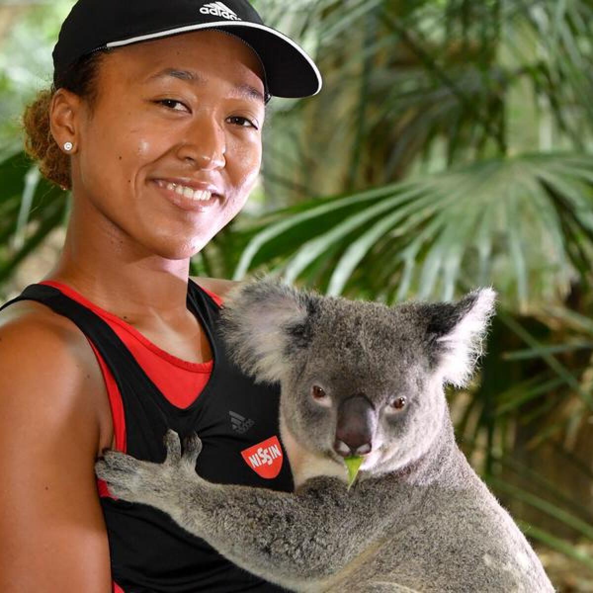 Tennis champion Naomi Osaka with a koala at Lone Pine Koala Sanctuary.