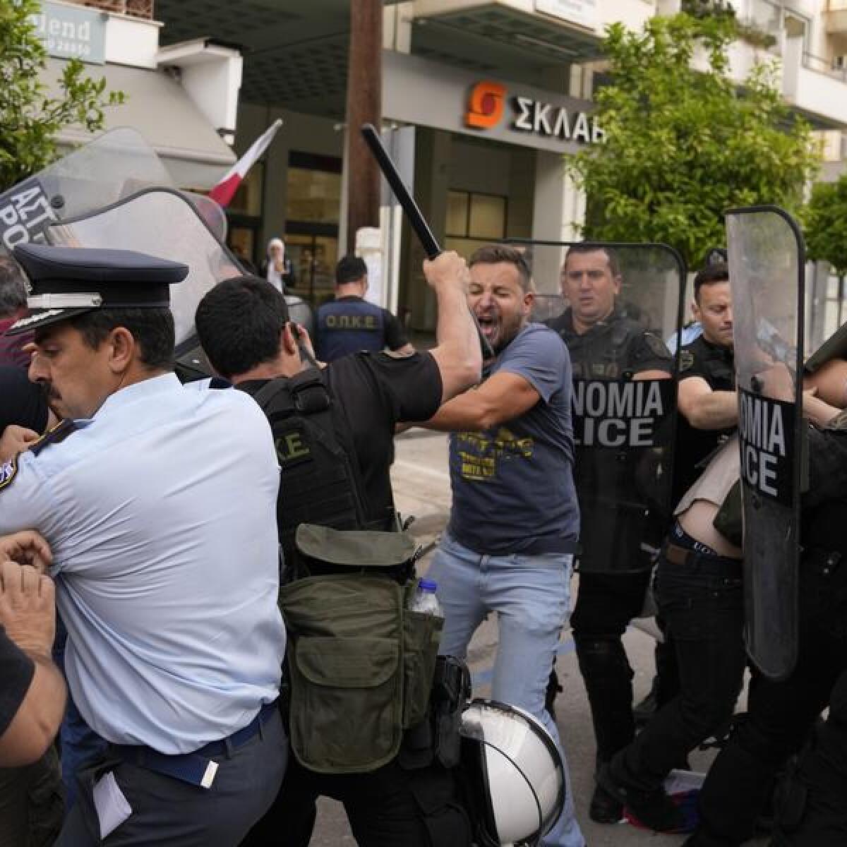 Police clash with protesters outside a court house in Kalamata