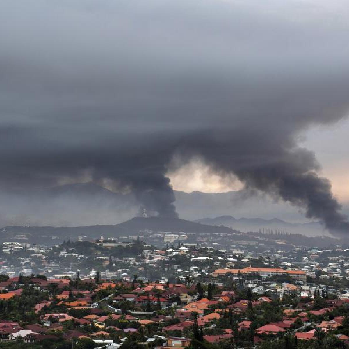 Smoke rises during protests in Noumea.