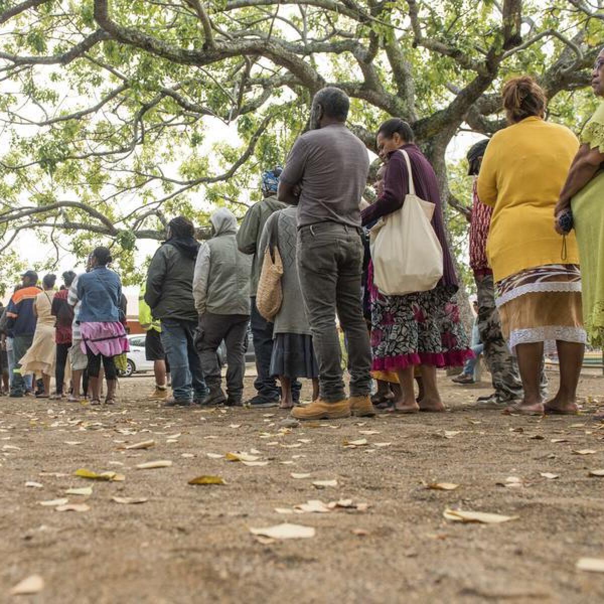 People wait in line to cast their votes in Noumea, New Caledonia