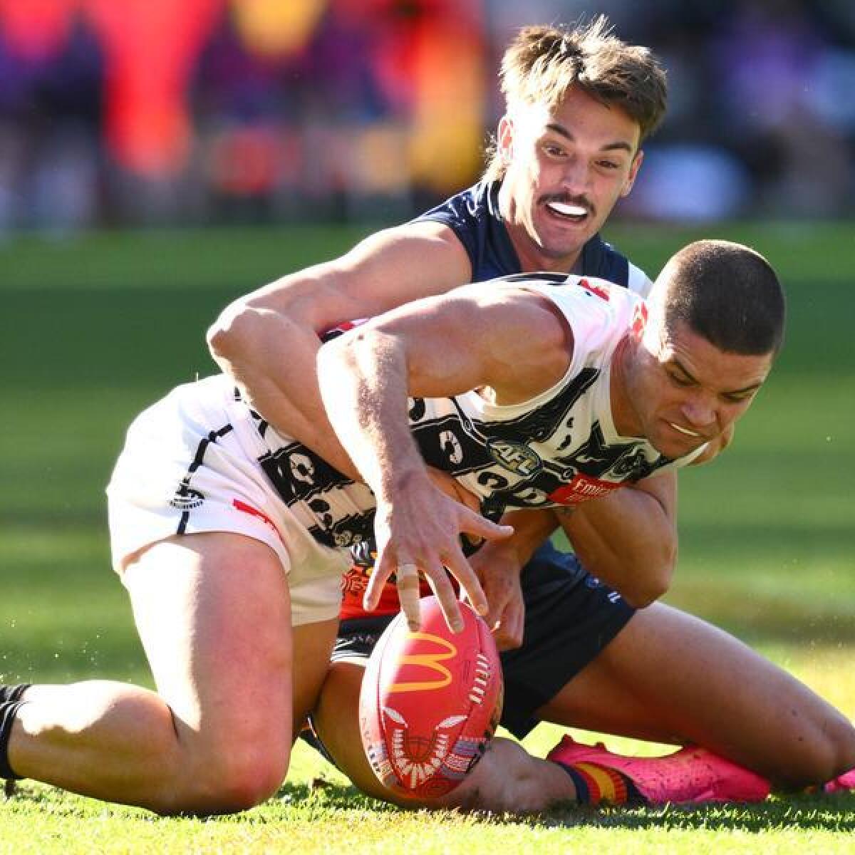 Luke Nankervis of the Crows tackles Lachie Sullivan of Collingwood.