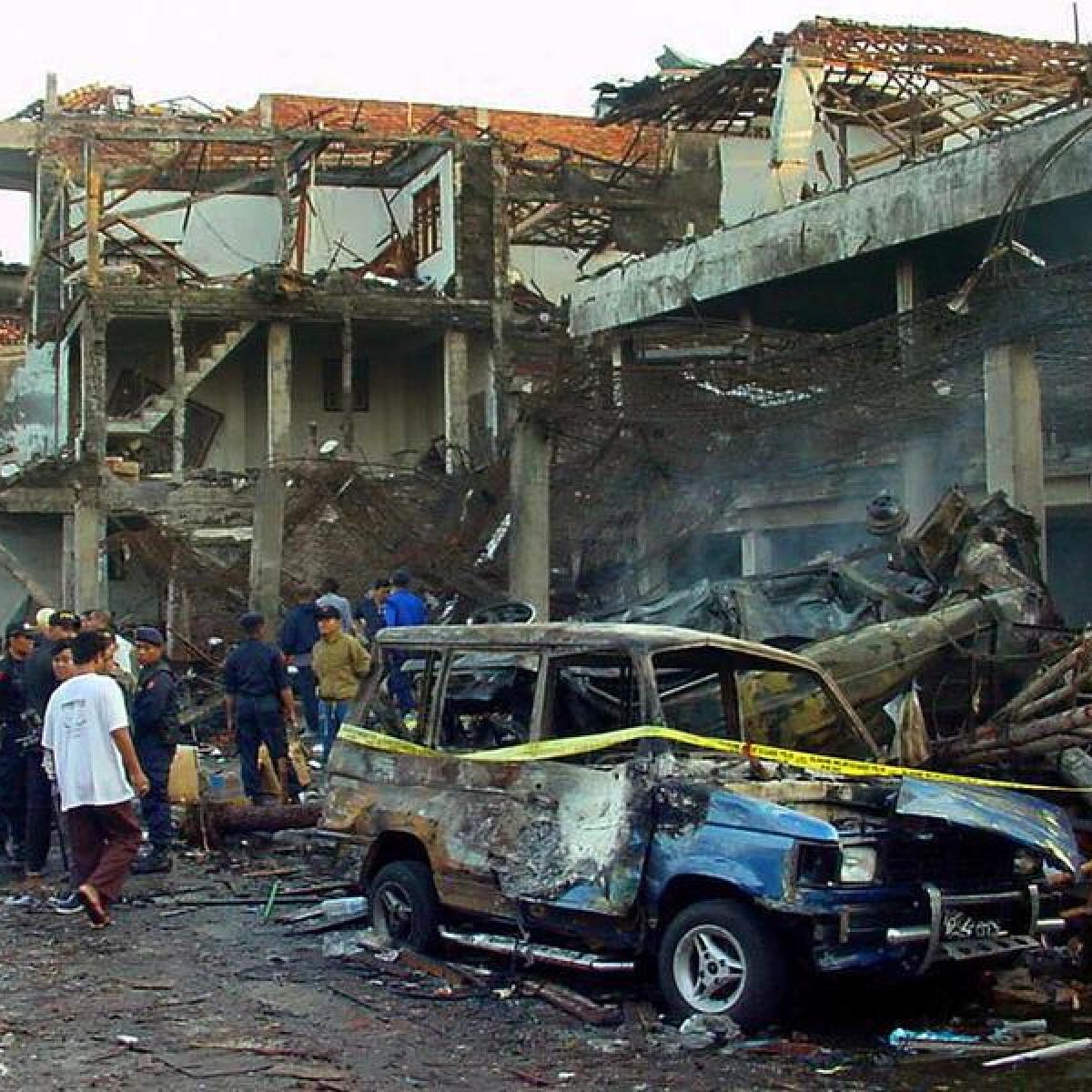 Police inspect the ruins of a Kuta nightclub in October 2002