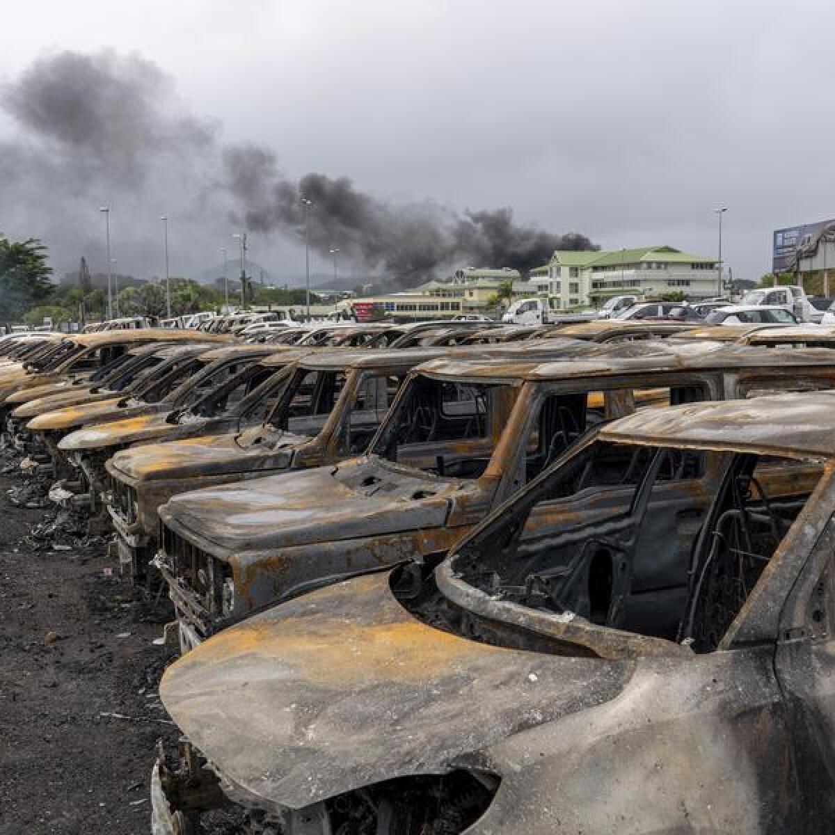 Burnt cars are lined up after unrest in Noumea, New Caledonia