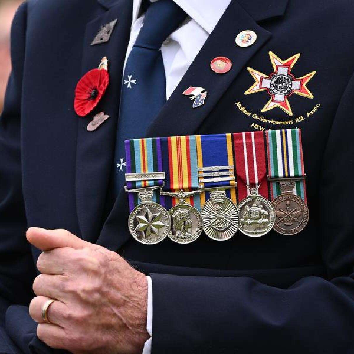 A person wearing medals on Anzac Day.