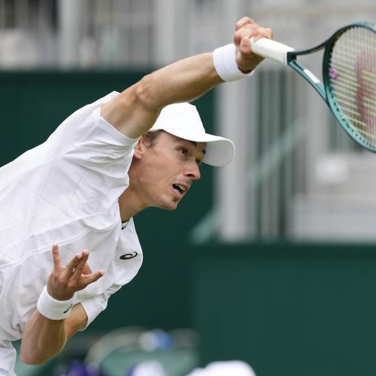 Alex de Minaur serves at Wimbledon.