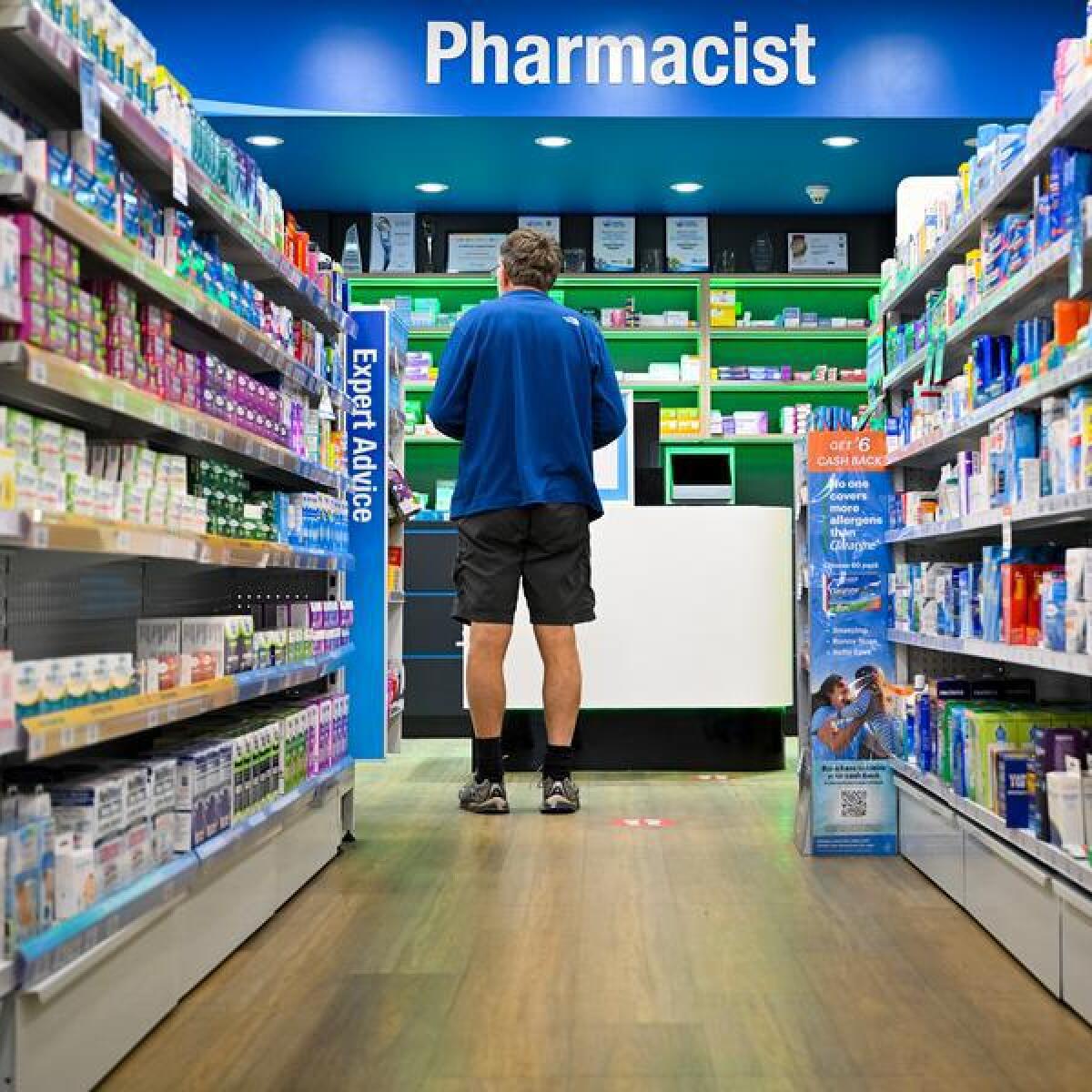 A customer waits at a pharmacy counter (file image)